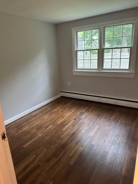 86 Seabrook Rd, Hyannis, MA 02601 - spare room featuring a baseboard radiator and dark wood finished floors