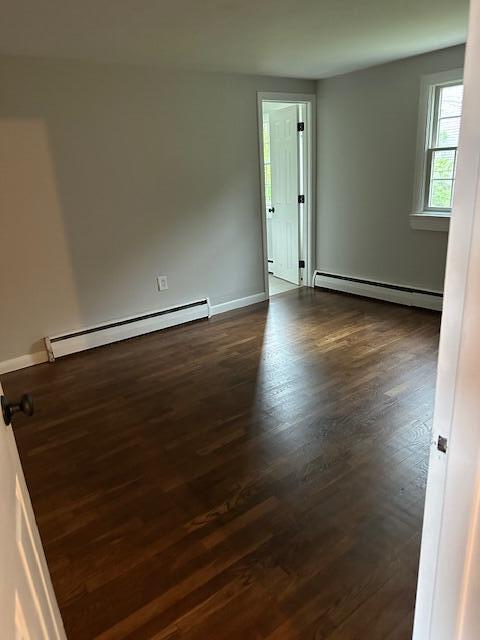 86 Seabrook Rd, Hyannis, MA 02601 - spare room featuring a baseboard heating unit and dark wood finished floors