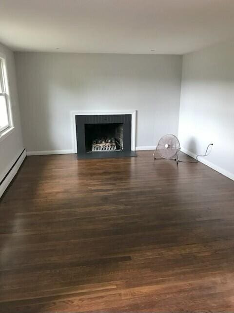 86 Seabrook Rd, Hyannis, MA 02601 - detailed view of wood finished floors, a fireplace with flush hearth, and baseboard heating