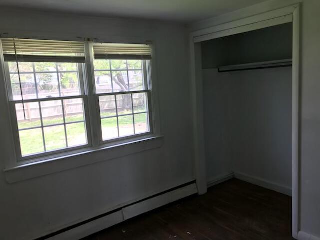 86 Seabrook Rd, Hyannis, MA 02601 - unfurnished bedroom with a baseboard radiator and dark wood finished floors