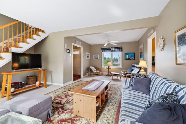 carpeted living area featuring stairs, a ceiling fan, and baseboards