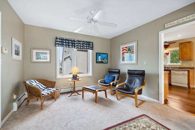 sitting room with ceiling fan, a baseboard radiator, baseboards, baseboard heating, and carpet