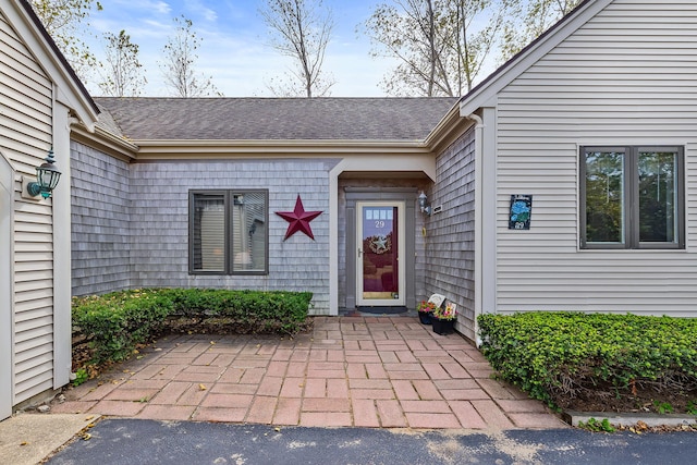 property entrance with a shingled roof