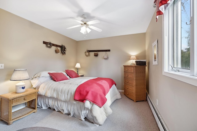 carpeted bedroom with baseboards, a baseboard heating unit, and a ceiling fan