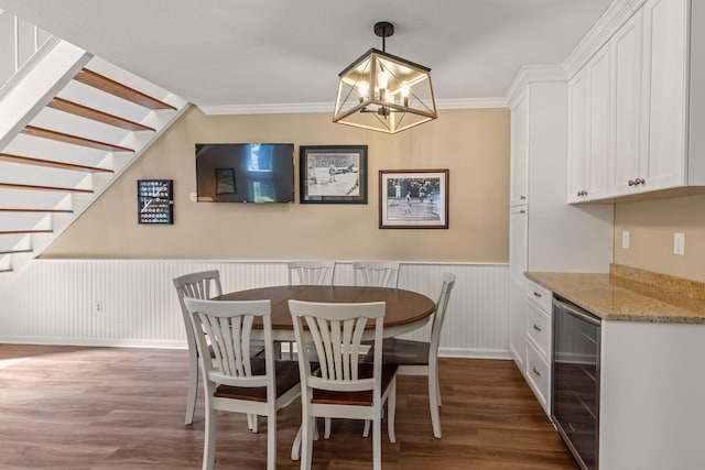 dining area featuring wainscoting, a chandelier, wine cooler, dark wood-style floors, and stairway