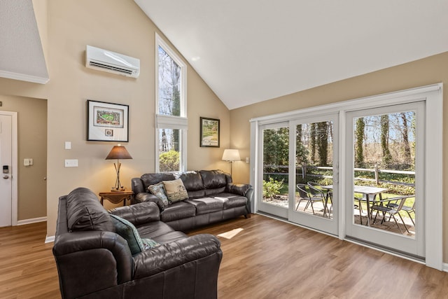 living room featuring baseboards, high vaulted ceiling, wood finished floors, and a wall mounted air conditioner