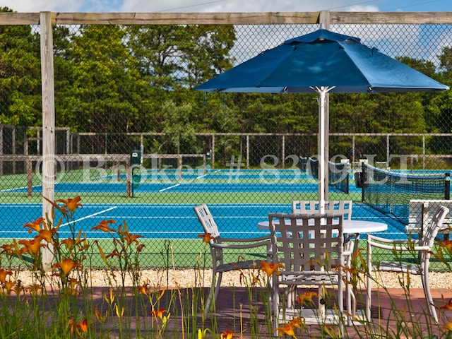 view of tennis court featuring fence