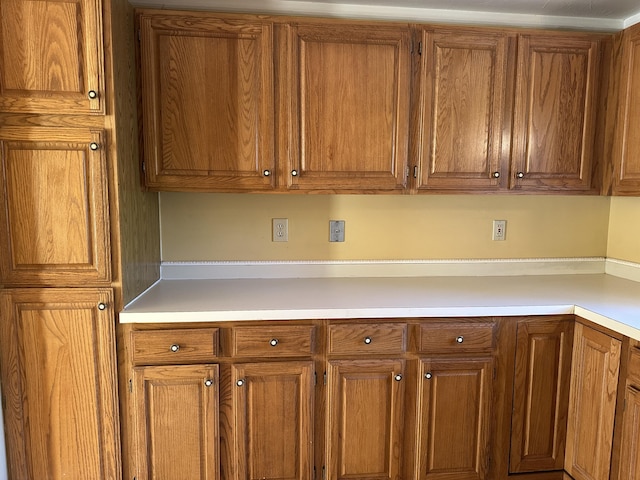 kitchen with brown cabinetry and light countertops