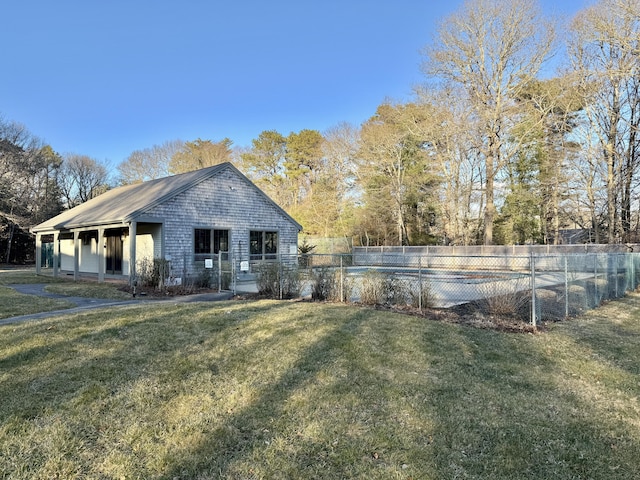 exterior space featuring a pool, fence, and a lawn