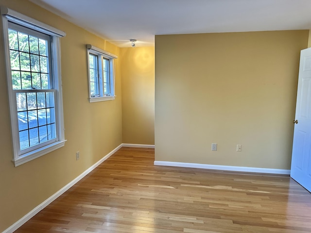 unfurnished room featuring light wood-style floors and baseboards