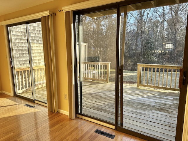 entryway featuring visible vents, baseboards, and hardwood / wood-style flooring