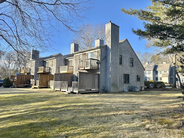 view of property exterior with a chimney and a lawn