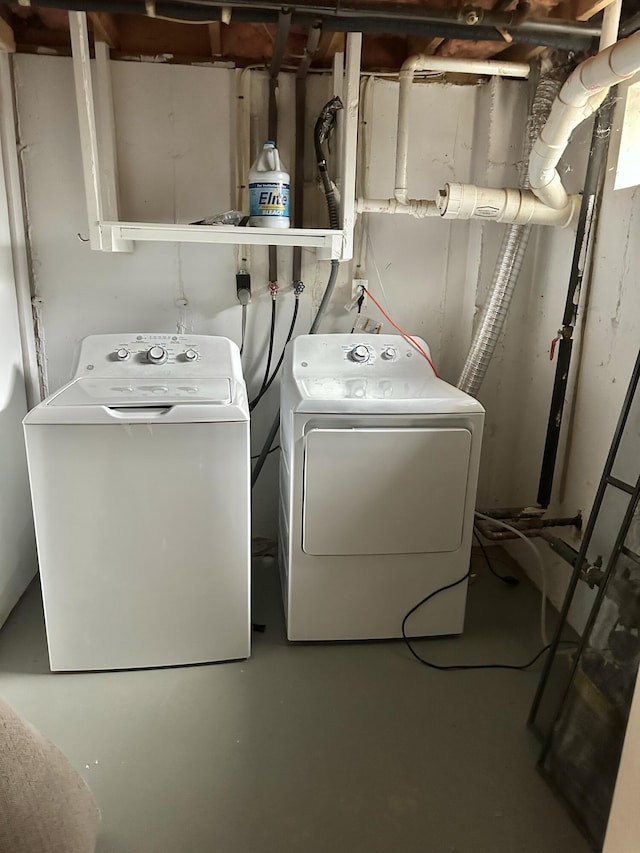 washroom featuring laundry area and washing machine and clothes dryer