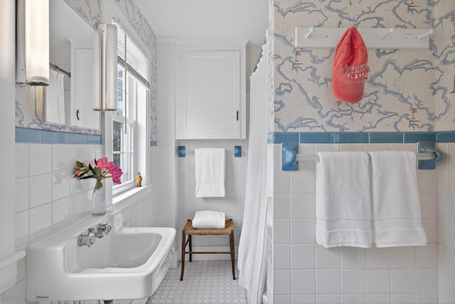 77 Pleasant Rd, West Harwich, MA 02671 - full bathroom featuring tile walls, wallpapered walls, wainscoting, a shower with shower curtain, and tile patterned floors