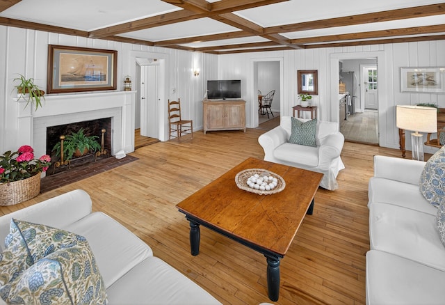 77 Pleasant Rd, West Harwich, MA 02671 - living area with beamed ceiling, light wood finished floors, and a brick fireplace