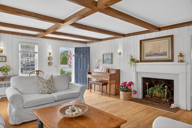 77 Pleasant Rd, West Harwich, MA 02671 - living room with beamed ceiling, light wood finished floors, a fireplace, and radiator heating unit