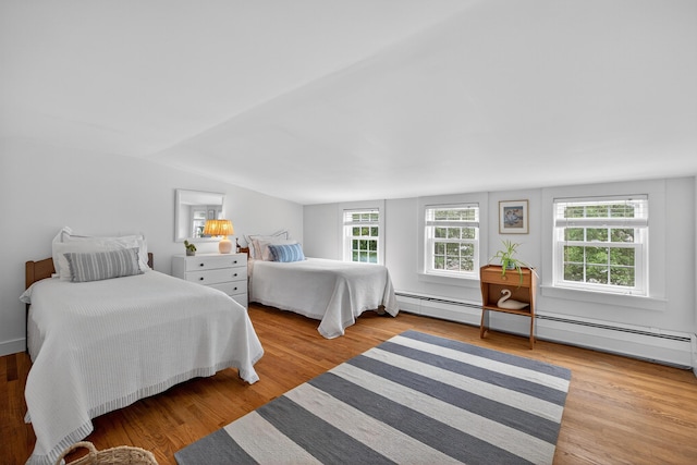 77 Pleasant Rd, West Harwich, MA 02671 - bedroom featuring baseboard heating, wood finished floors, and lofted ceiling