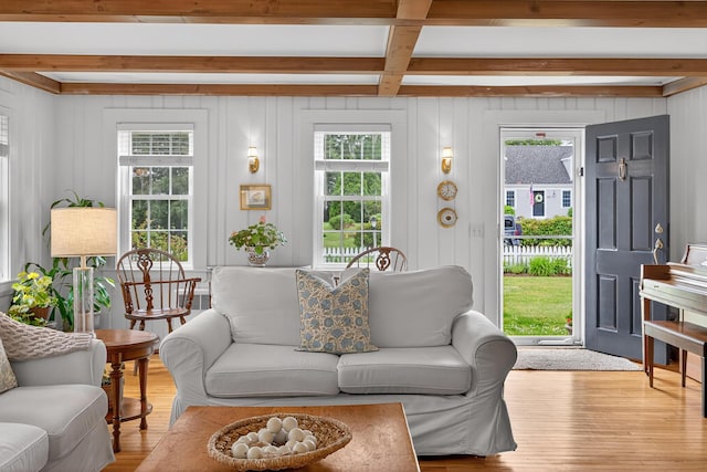 77 Pleasant Rd, West Harwich, MA 02671 - living room with beamed ceiling, wood finished floors, plenty of natural light, and a decorative wall