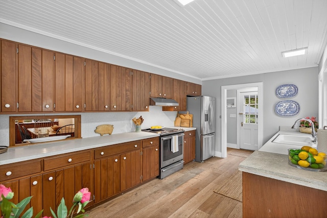 77 Pleasant Rd, West Harwich, MA 02671 - kitchen featuring appliances with stainless steel finishes, under cabinet range hood, light wood-type flooring, brown cabinetry, and ornamental molding