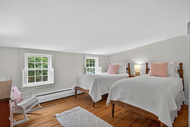 77 Pleasant Rd, West Harwich, MA 02671 - bedroom with a baseboard radiator, multiple windows, and wood finished floors