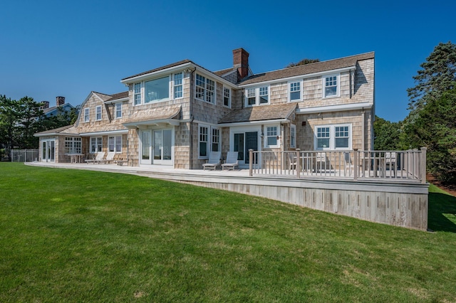 rear view of property featuring a patio area and a lawn