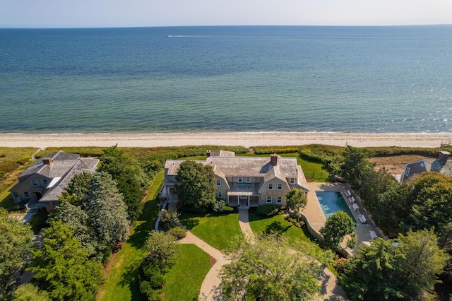 drone / aerial view with a water view and a beach view