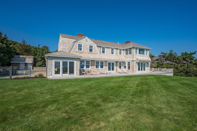 back of house with a patio area and a yard