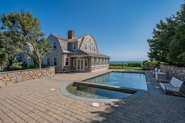 view of pool with a patio and french doors