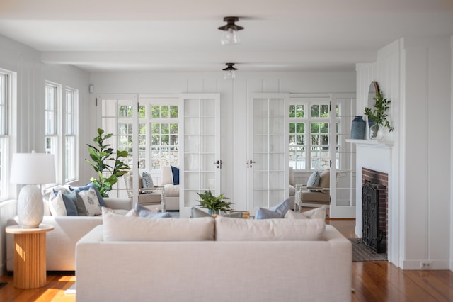 living room with a fireplace, wood finished floors, and french doors