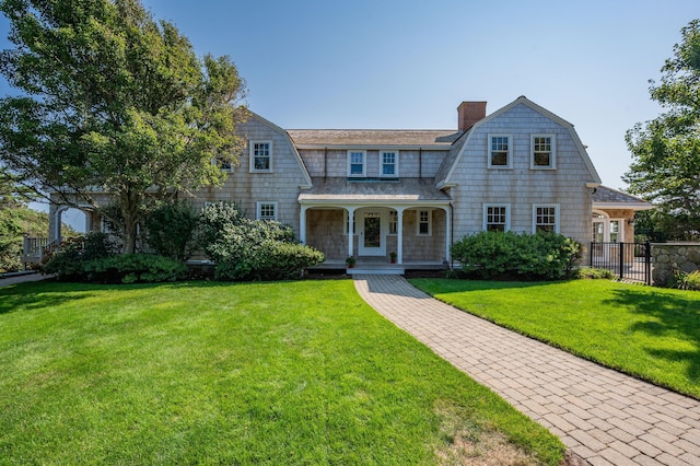 view of front of home featuring covered porch and a front lawn