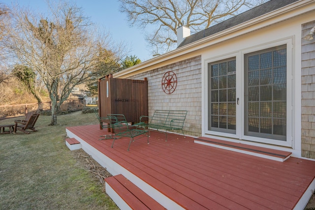 wooden terrace featuring a lawn