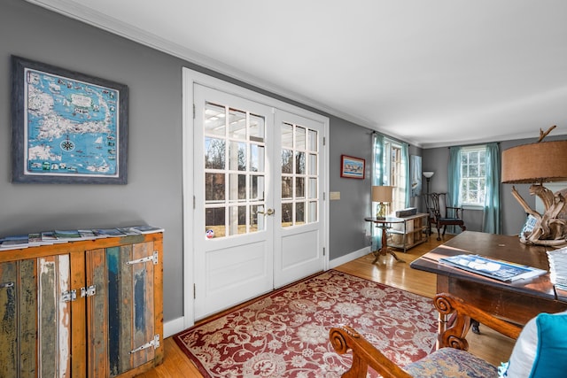 interior space featuring crown molding, hardwood / wood-style floors, and french doors