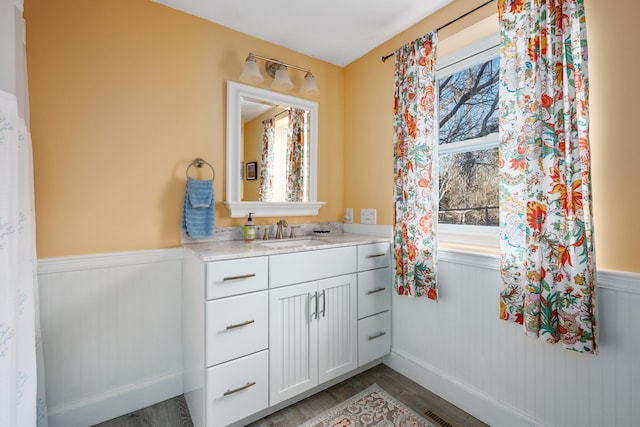 bathroom with vanity and hardwood / wood-style flooring