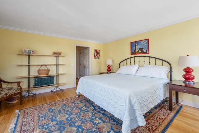 bedroom featuring crown molding and wood-type flooring