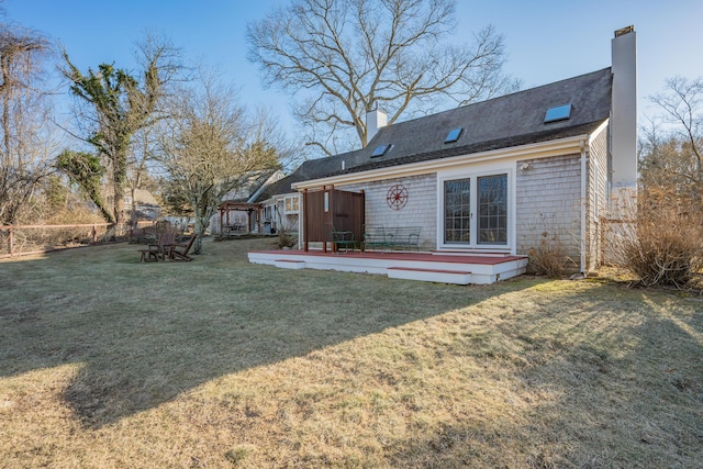 rear view of property featuring a yard