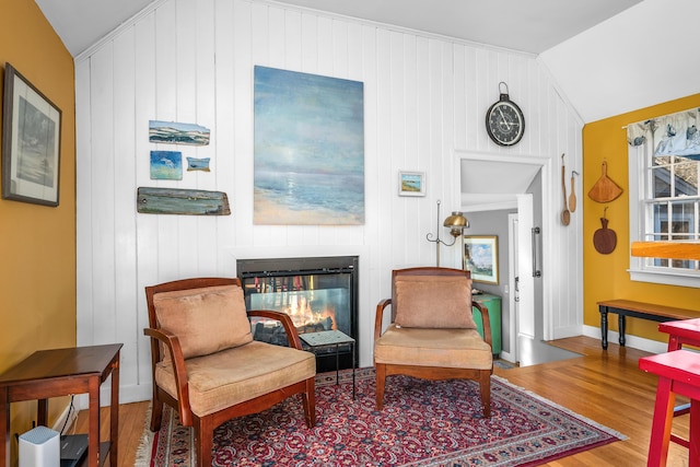 sitting room with hardwood / wood-style flooring and vaulted ceiling