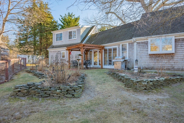 rear view of property featuring a lawn and a pergola