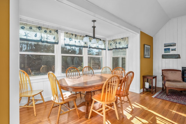 dining area featuring light hardwood / wood-style floors and vaulted ceiling