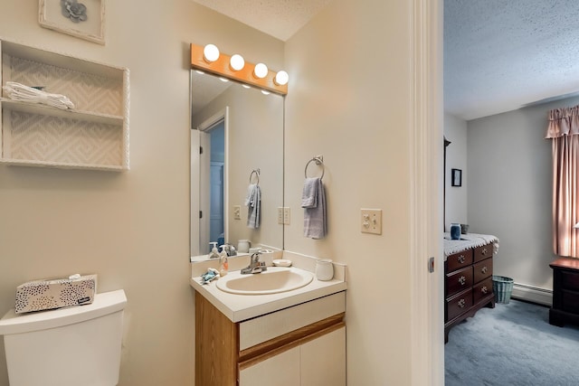 bathroom with vanity, toilet, a textured ceiling, and baseboard heating