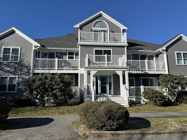 view of front facade with covered porch and a balcony