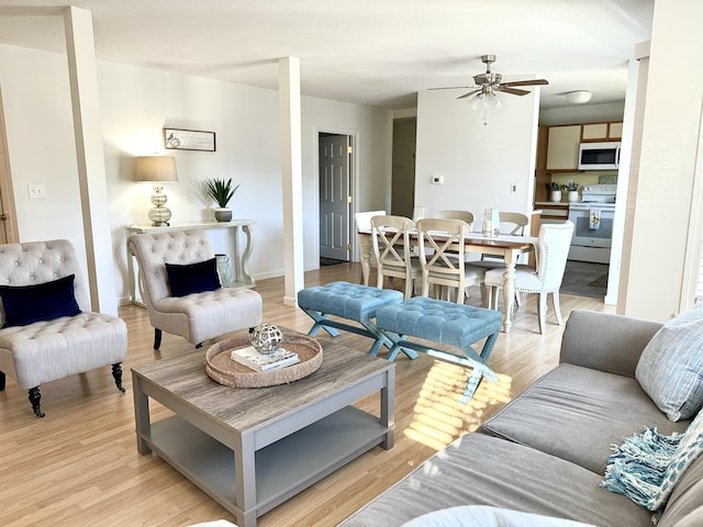 living room featuring light wood-type flooring and ceiling fan