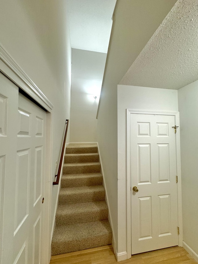 stairs featuring hardwood / wood-style floors