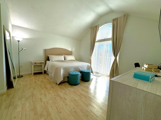 bedroom featuring light hardwood / wood-style floors and lofted ceiling