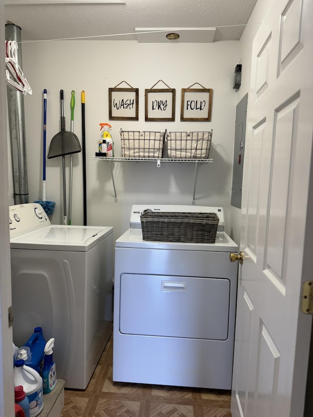 clothes washing area featuring independent washer and dryer, dark parquet floors, a textured ceiling, and electric panel