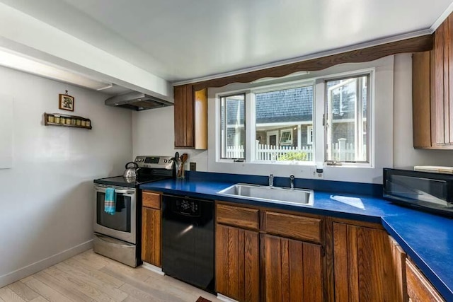 232 Robbins Hill Rd, Brewster, MA 02631 - kitchen with light wood-type flooring, black appliances, a sink, dark countertops, and baseboards