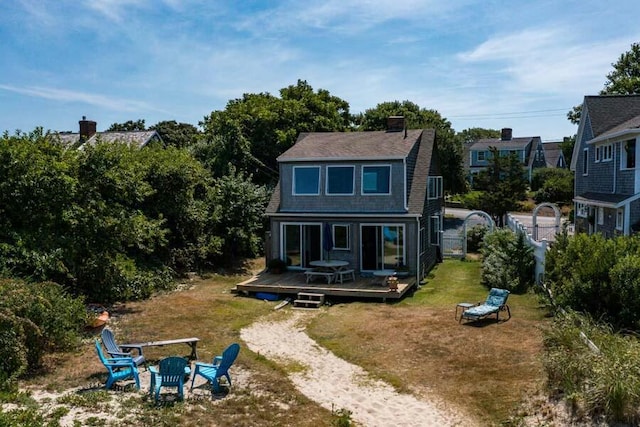 232 Robbins Hill Rd, Brewster, MA 02631 - back of house with an outdoor fire pit, a yard, a wooden deck, and fence