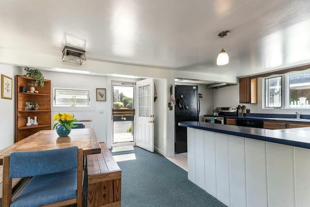 232 Robbins Hill Rd, Brewster, MA 02631 - kitchen featuring hanging light fixtures, a sink, dark countertops, stainless steel electric range, and light colored carpet