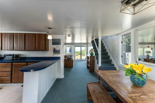 232 Robbins Hill Rd, Brewster, MA 02631 - kitchen with a toaster, carpet flooring, a peninsula, and dark countertops
