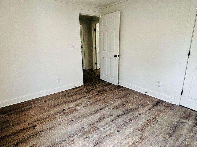 379 Main St, Mashpee, MA 02649 - unfurnished bedroom with wood finished floors, baseboards, and crown molding