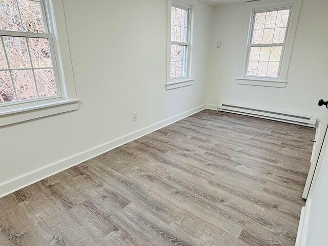 379 Main St, Mashpee, MA 02649 - empty room with a baseboard radiator, wood finished floors, and baseboards